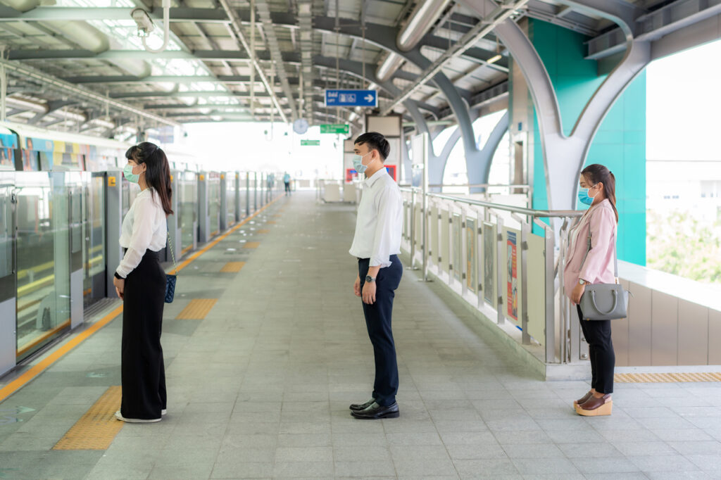 Three Asian people wearing mask standing distance of 1 meter fro